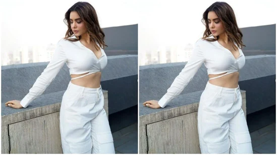 Aamna paired a full-sleeved cropped stain shirt with a pair of white cargo trousers. In beach wavy curls, Aamna looked picture-perfect.(Instagram/@aamnasharifofficial)